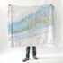A person standing with a nautical chart blanket draped over their shoulders, displaying detailed map patterns.