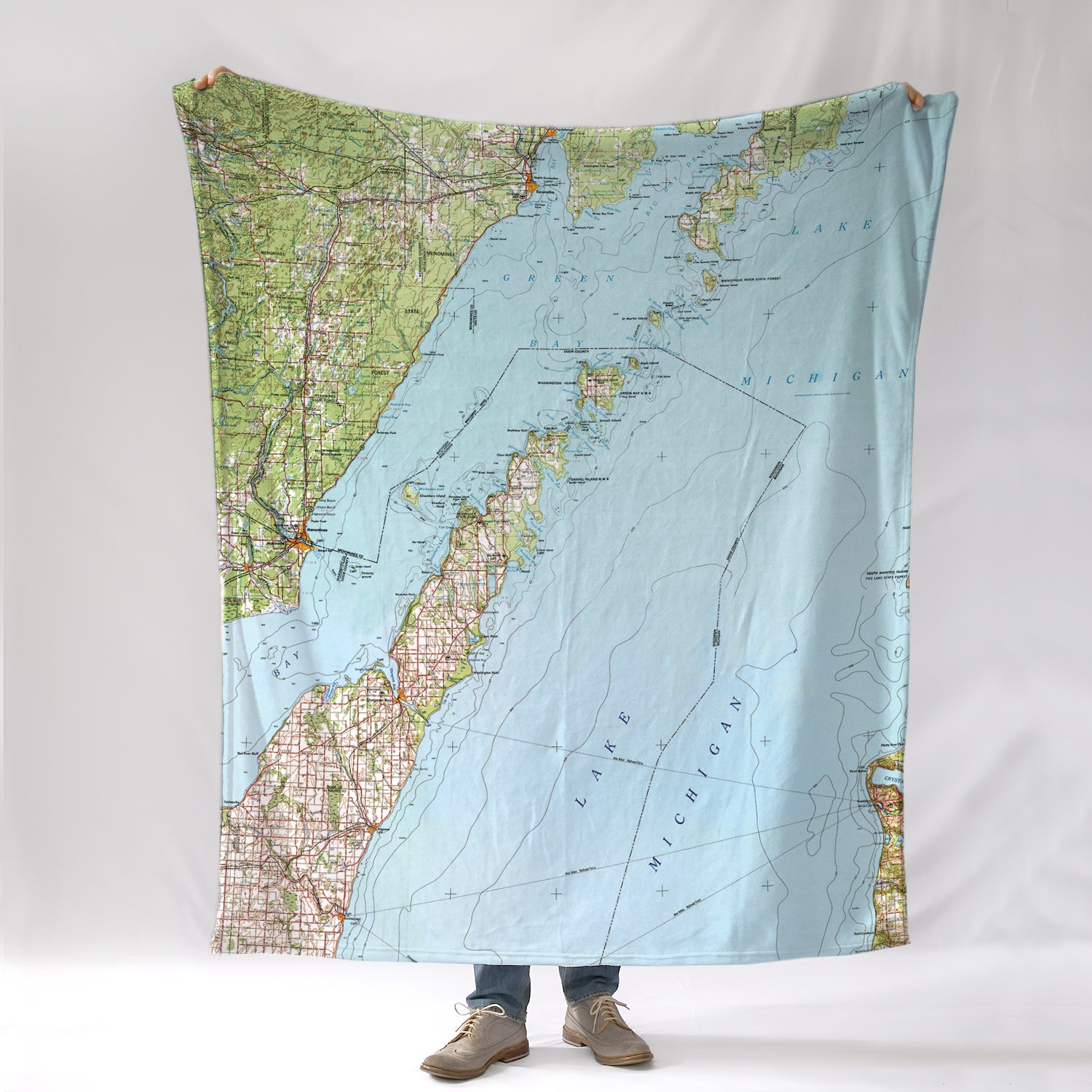 Door County, WI map blanket with a person standing underneath on a white background