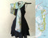 Black dress with a map-patterned scarf draped over a hanger, next to a map of Cape Cod.