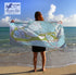 Person holding a map towel on a beach with 'Maritime Tribes' logo.