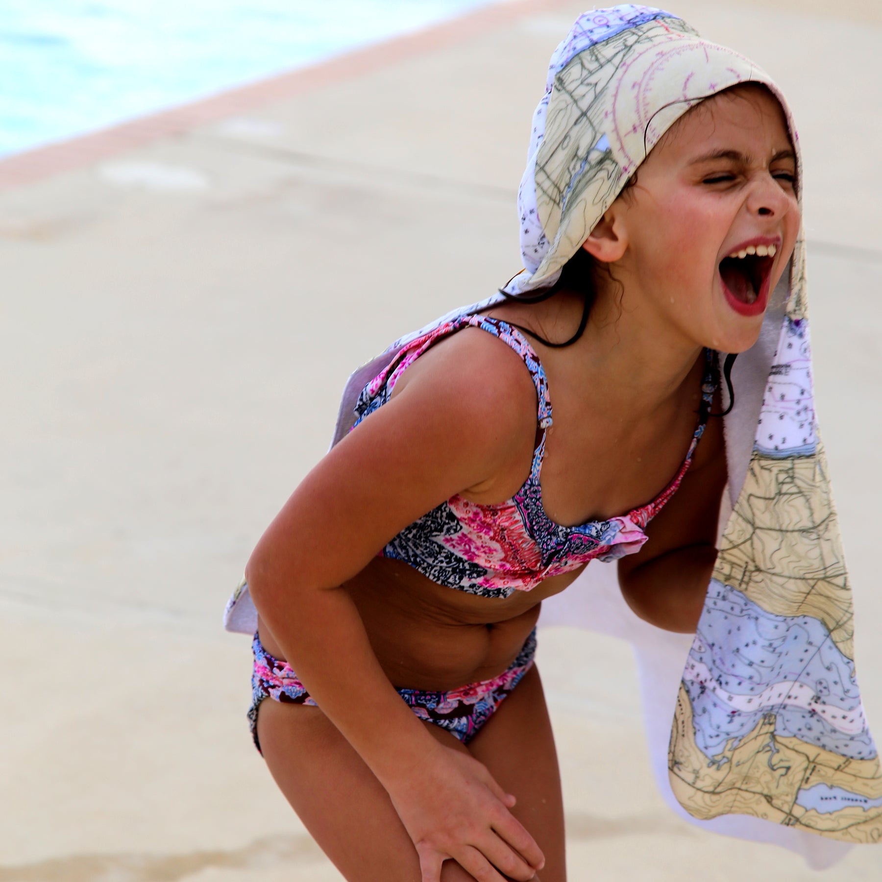 Child in a colorful hooded beach towel 