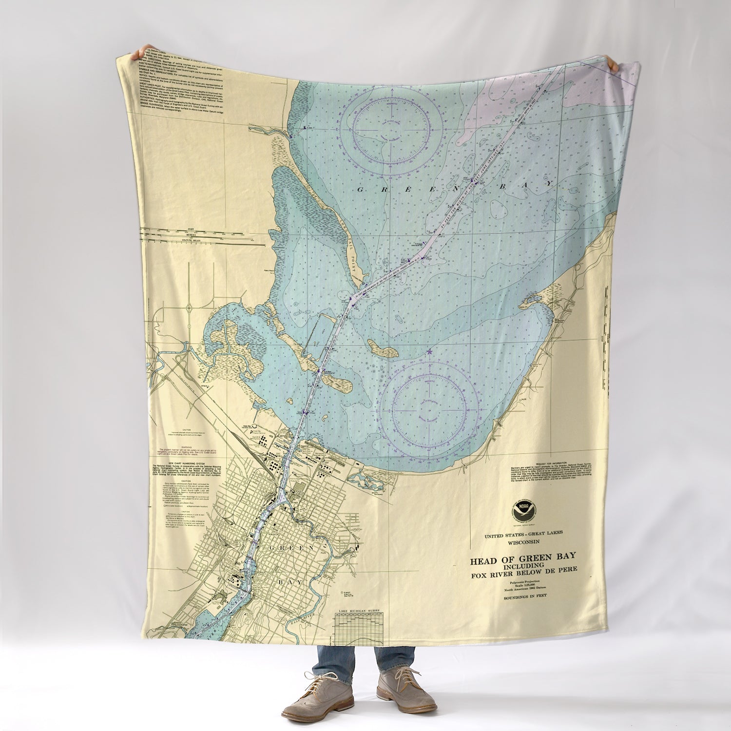 Map blanket with a person standing underneath on a white background